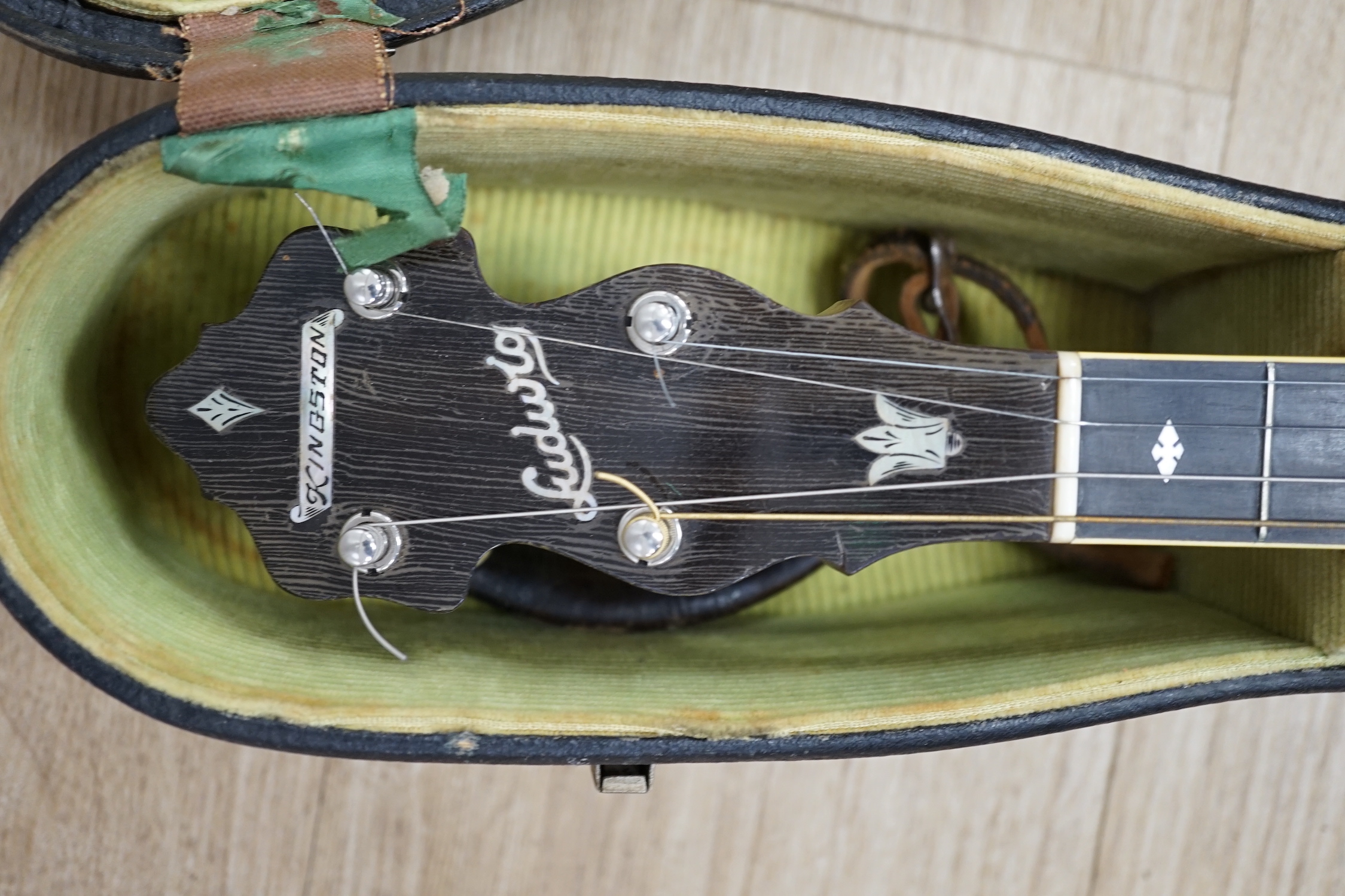 A cased 1920s Ludwig 'Kingston', USA tenor four string banjo, inlaid back, mother of pearl inlay to the fretboard, modern Remo skin, length of body 34cm, overall length 87cm, in a fitted hard case